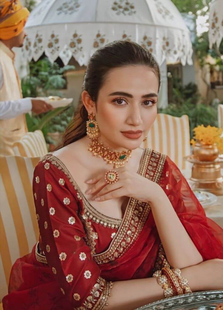 Traditional bridal makeup with red sari.